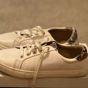 White sneaker with snake print detail